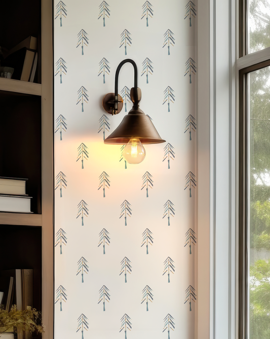 Painted Pine Wallpaper with a playful evergreen tree pattern in navy and jade against a white background.