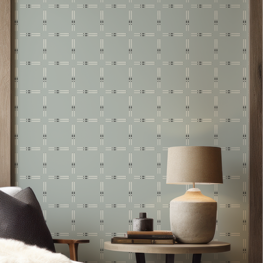 Close-up of Ski Check Sage Green Wallpaper highlighting the white ski motif, deep green bindings, and soft sage green background.