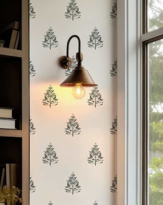 Close-up of Woodland Pine Wallpaper showing the botanical pine tree illustration in muted green against a light neutral background.